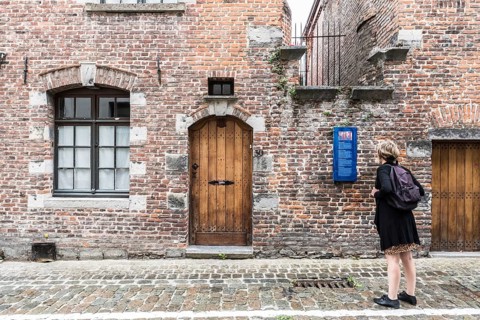 Tournai Doornik, Walloon Region, Belgium, 08 14 2019 Local tourist in summer dress looking at the