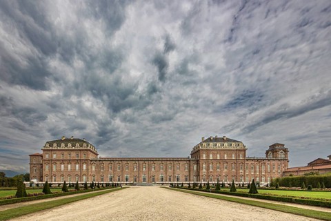 Impressive view of a large baroque palace with clouds in the sky, Palace of Venaria Reale,