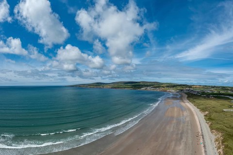 An aerial panorama view of the Bray Head cliffs and headland on Valentia Island at sunset aerial