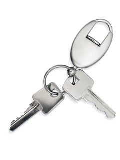 Metal key with trinket over white background