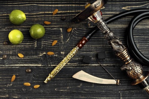 Dismantled parts of hookah on a wooden background with lime fruit. Top view. Flat lay. Copy space.