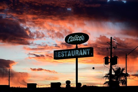 Restaurant sign in front of a dramatic evening sky, Kingman, Arizona, USA