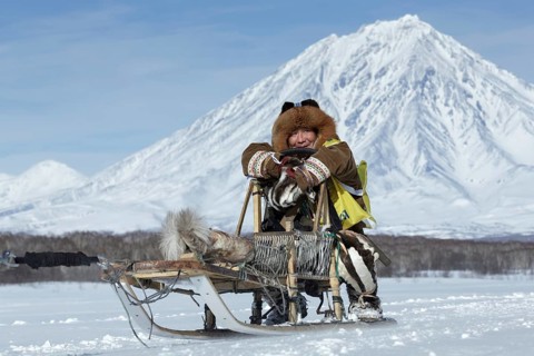 KAMCHATKA, RUSSIA, FEB 25, 2017: Kamchatka musher Mandyatov Roman dressed in national clothes rides