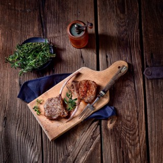 Grilled lamb chops on an old board