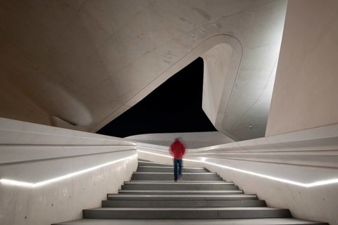 Unrecognized person walking at the stairs leading to a bright open space. Eleftheria square Nicosia