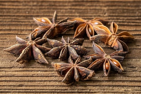 Dried star anise spice on vintage wooden board