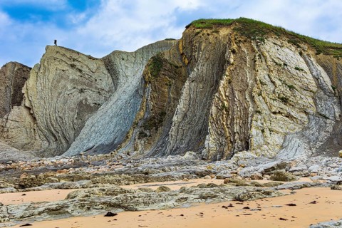 Coast of the Atlantic Ocean. Cantabria. Noon on the beach of Playa di Arnia, Spain. Photographer