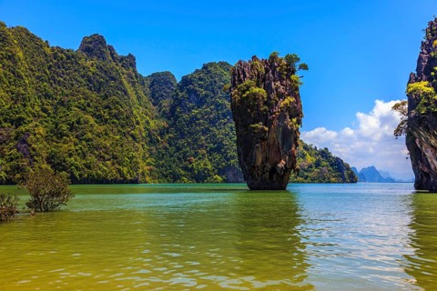 The tourist season in Thailand. Calm and warm sea and picturesque quaint island. James Bond Island