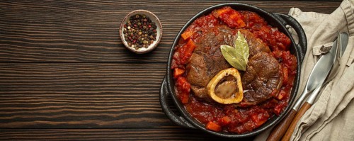 Traditional Italian dish Ossobuco all Milanese made with cut veal shank meat with vegetable tomato