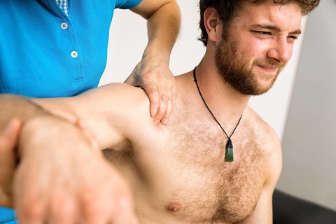 An image of a young man at the physio therapy with pain