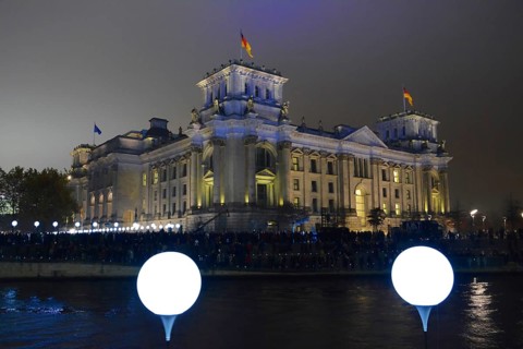 Berlin Reichstag building with light balloons of the former course of the Wall