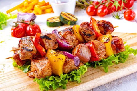 Tasty and colorful meat skewers with peppers and onions