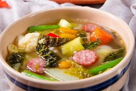 Delicious autumnal vegetable soup with sausage and bacon