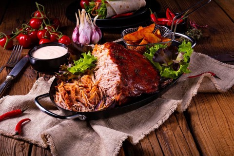 Delicious pulled pork with jacket potato quarters