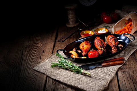 Grilled chicken legs in a barbecue marinade with sweet potatoes