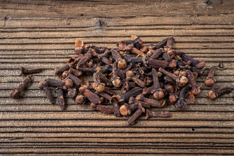 Clove spice on a wooden board, Syzygium aromaticum