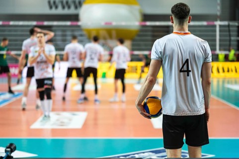 Volleyball player serves ball during the match