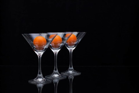 Three glasses of champagne with golf balls