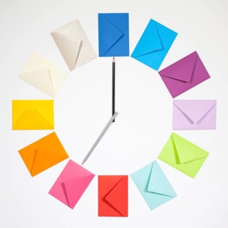 Twelve envelopes isolated on white background. Clock of colored envelopes for Christmas mailing