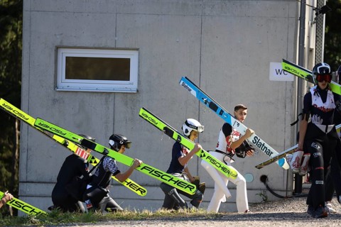Ski jumpers on their way to the inrun tower at the Alpencup Ski Jumping Hinterzarten 2024,
