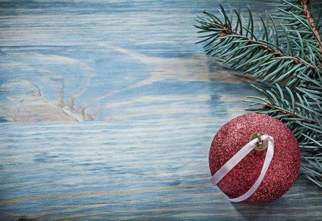 Pine branch Christmas ball on wooden board copy space holidays concept