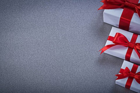 White gift boxes with presents on grey surface holidays concept