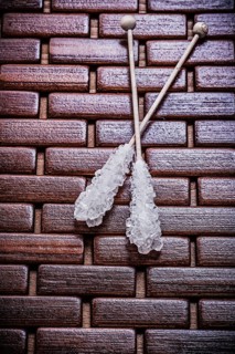 Tasty sugar sticks on wooden matting food and drink concept