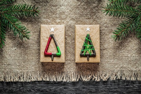 Vintage sacking pine branch Christmas gift box on wooden board