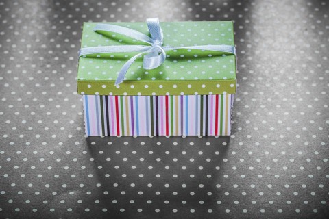 Present box on red tablecloth horizontal image celebrations concept