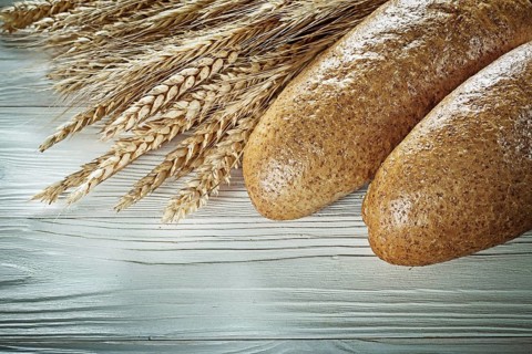 Bread stick wheat ears on white board