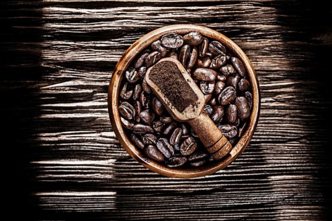 Ground coffee crops bowl scoop on wooden board