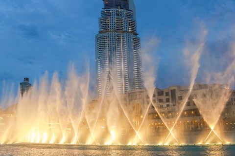 The Dancing Fountain of Dubai performs to the beat of the music at night show on lake area