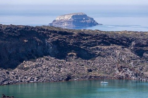 Volcanic island Palea Kameni, behind Aspronisi, white island, uninhabited island, part of the