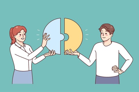 Happy businesspeople connect pieces of jigsaw find solution together. Smiling employees look for