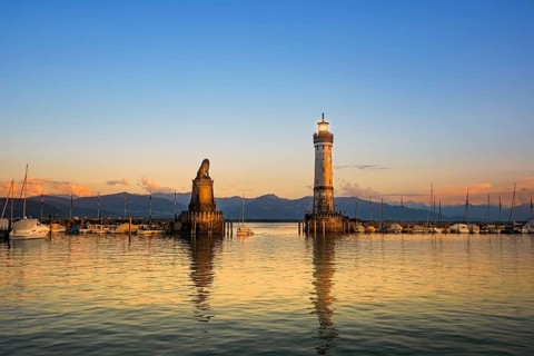 Harbour entrance of Lindau with lighthouse and sculpture of lion Lindau, Germany