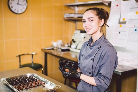 Subject profession and cooking pastry. young Caucasian woman with tattoo of pastry chef in kitchen