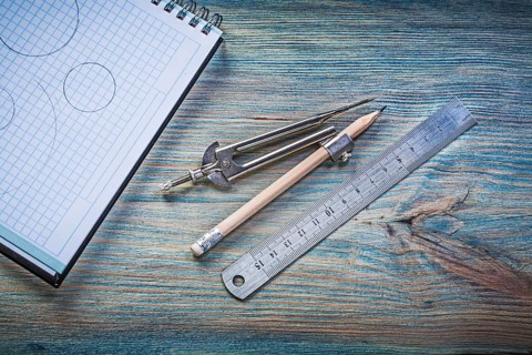 Checked copybook ruler divider pencil on vintage wood board