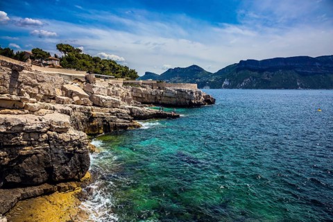 Abrupt stony coast and turquoise sea surface. Famous National Park Calanques on the Mediterranean