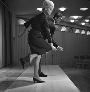 Dancing in the 1960s. The dance Hully Gully is being made popular and here are men and women