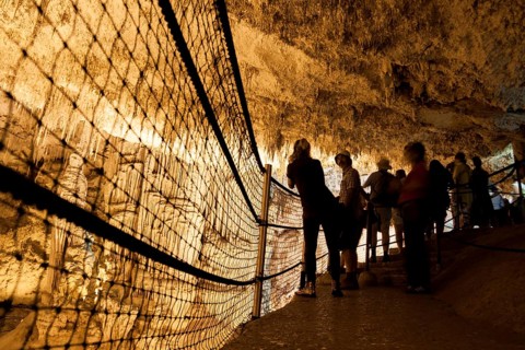 Tourists admire the incredible cave of Neptune. Alghero, Sardinia. Italy