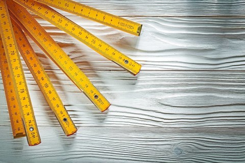 Wooden meter on white board construction concept