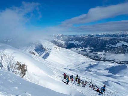Situation on the summit of Haengst in Soerenberg, Switzerland, on a sunny winter day: A group of
