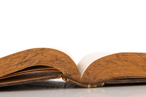Old open book isolated over white background