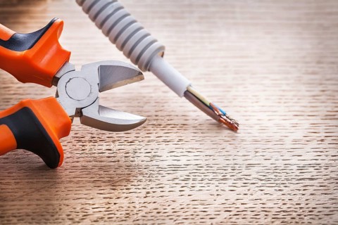 Opened mippers with cable on wooden board construction concept