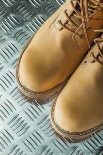 Waterproof safety boots on corrugated metal sheet