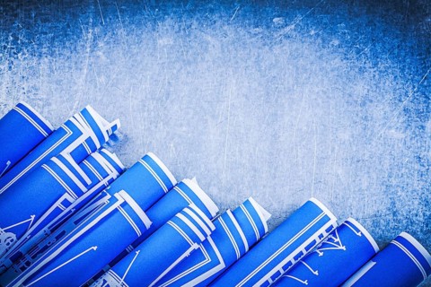 Blue construction drawings on metallic background top view maintenance concept