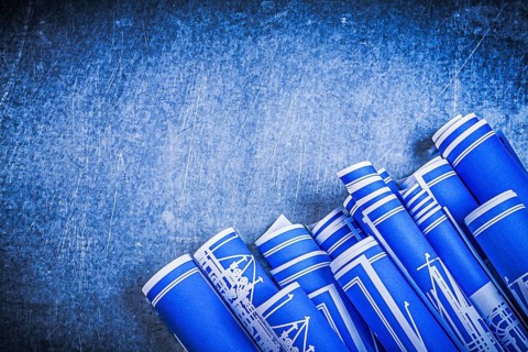 Blue blueprints on metallic background construction concept