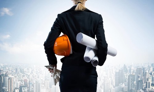 Woman architect standing with construction drawings and hardhat in hands. Back view of contractor