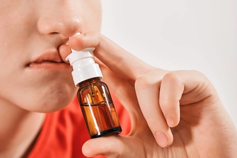 Blond Boy drips nose drops from runny nose. Treatment of colds and allergic rhinitis. Selective