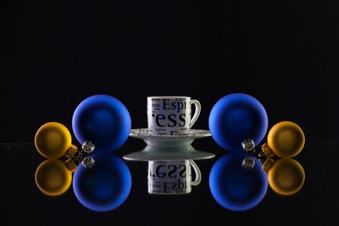 Cup of coffee and Christmas decoration on the glass table